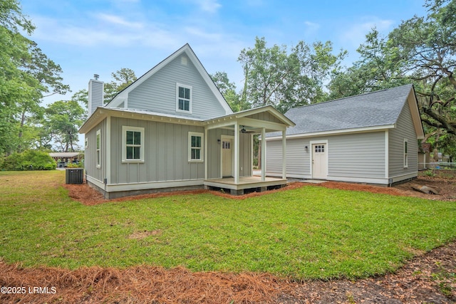 9 Attaway Ln, Beaufort, SC 29907 - back of house featuring board and batten siding, a chimney, a porch, and a yard
