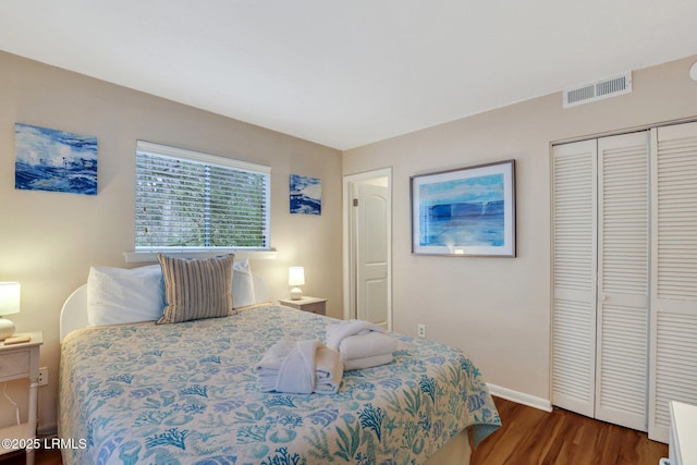 bedroom featuring dark hardwood / wood-style flooring and a closet