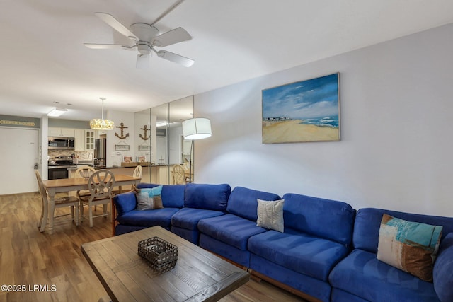 living room with dark hardwood / wood-style floors and ceiling fan