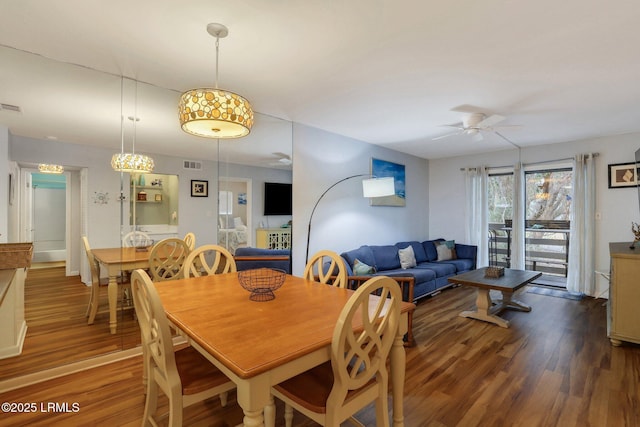 dining space with dark wood-type flooring and ceiling fan