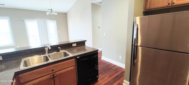 25 Kings Cross Ct, Beaufort, SC 29902 - kitchen with freestanding refrigerator, dishwasher, a sink, dark countertops, and dark wood finished floors