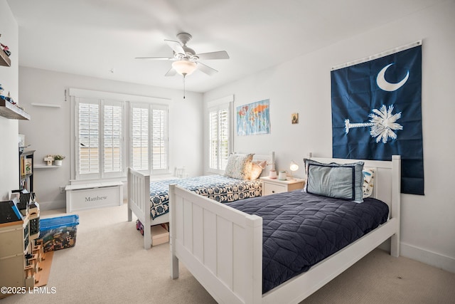 carpeted bedroom with baseboards and ceiling fan