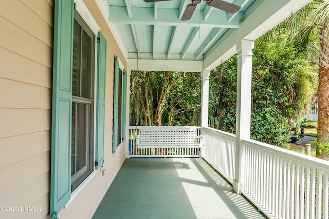 balcony with covered porch and ceiling fan