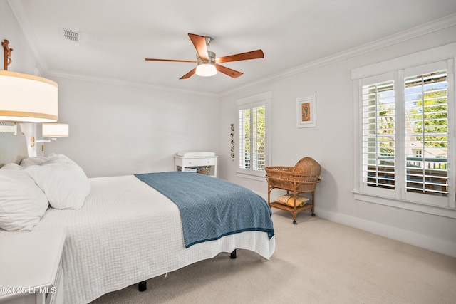 bedroom with visible vents, crown molding, baseboards, a ceiling fan, and carpet