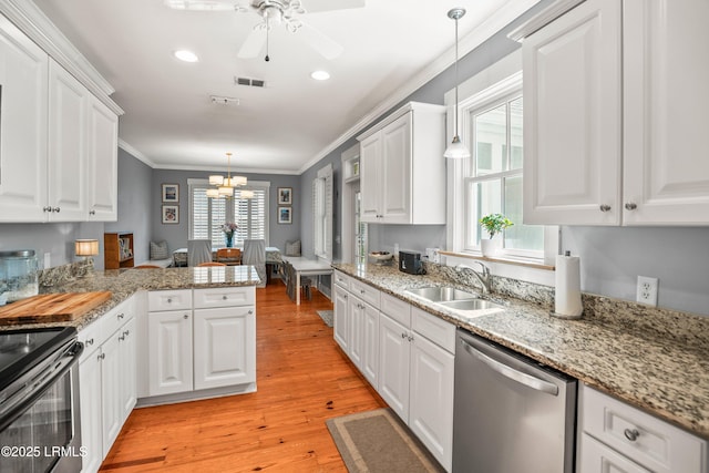 kitchen featuring visible vents, white cabinets, a sink, light wood finished floors, and dishwasher