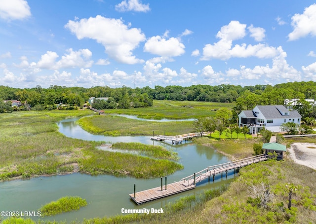 drone / aerial view featuring a water view and a wooded view