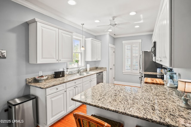 kitchen featuring stainless steel dishwasher, a sink, a ceiling fan, and recessed lighting