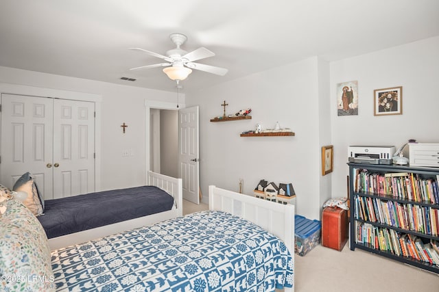 carpeted bedroom with a closet, a ceiling fan, and visible vents