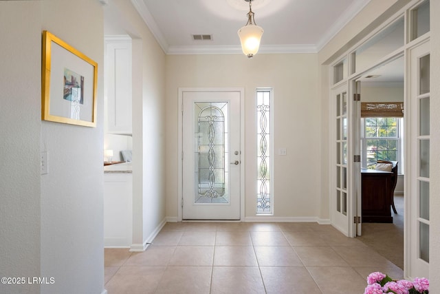 entryway featuring light tile patterned floors, baseboards, visible vents, and ornamental molding