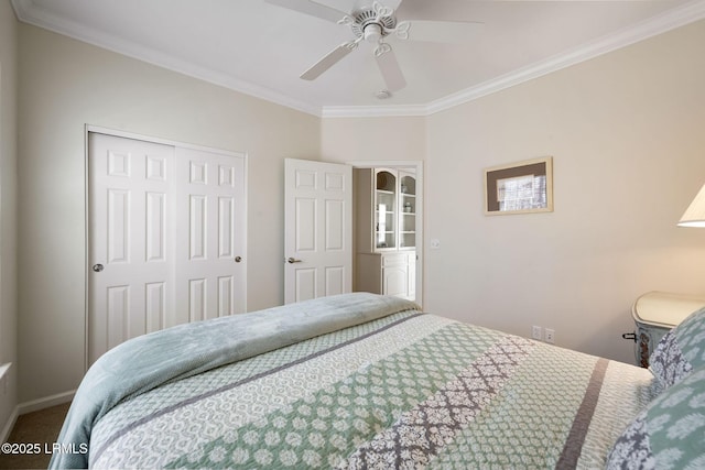 bedroom featuring a ceiling fan, a closet, and ornamental molding