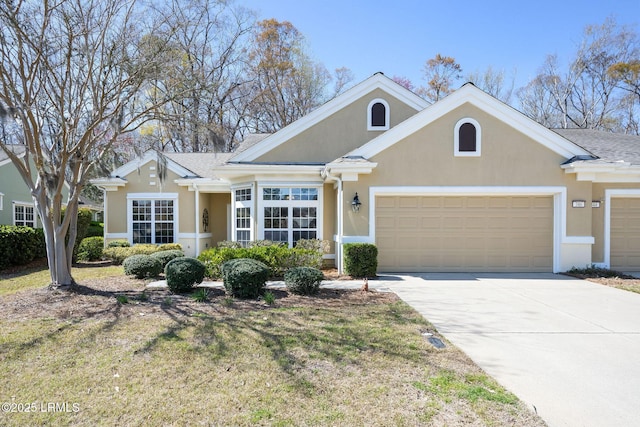 view of front of home featuring stucco siding, a garage, and driveway