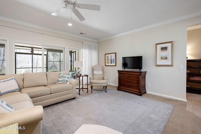 living room featuring a ceiling fan, baseboards, visible vents, crown molding, and light colored carpet