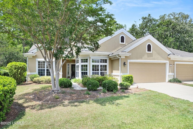 346 Landing Ln, Bluffton, SC 29909 - view of front of home featuring concrete driveway, an attached garage, a front lawn, and stucco siding