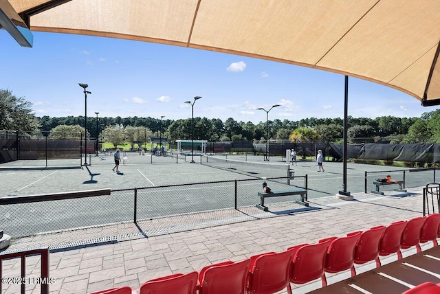 view of tennis court featuring fence