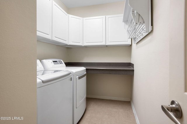 laundry room with cabinet space, independent washer and dryer, and baseboards