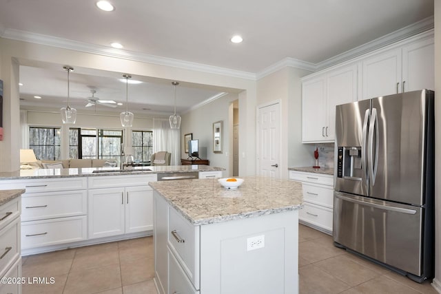 kitchen with a sink, appliances with stainless steel finishes, a center island, and light tile patterned floors