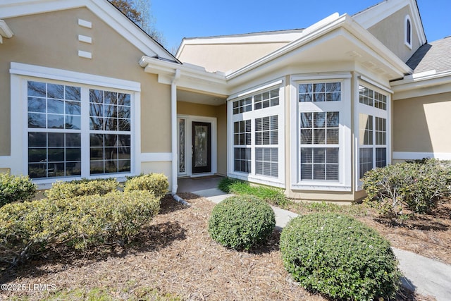 entrance to property with stucco siding