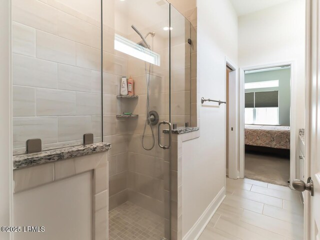 1872 Hearthstone Lake Dr, Ridgeland, SC 29936 - full bath with ensuite bath, a shower stall, tile patterned flooring, and baseboards