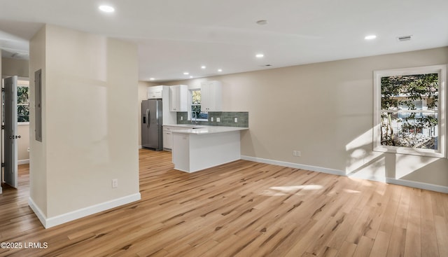 416 Meritta Ave, Beaufort, SC 29902 - kitchen featuring white cabinets, stainless steel refrigerator with ice dispenser, light wood-style floors, visible vents, and a sink