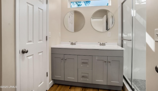 416 Meritta Ave, Beaufort, SC 29902 - bathroom with a shower stall, double vanity, a sink, and wood finished floors