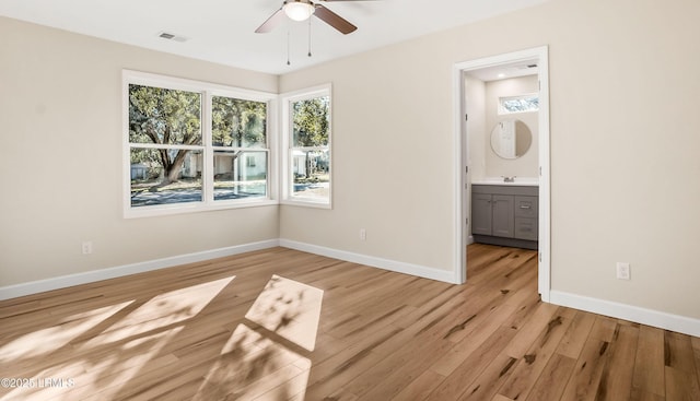 416 Meritta Ave, Beaufort, SC 29902 - unfurnished bedroom with a sink, visible vents, light wood-style flooring, and baseboards