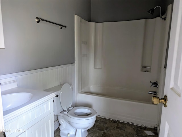 full bathroom with washtub / shower combination, vanity, and toilet