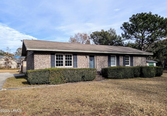 ranch-style home with a front lawn