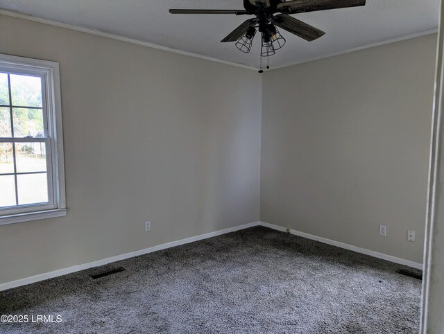 carpeted spare room with ornamental molding and ceiling fan