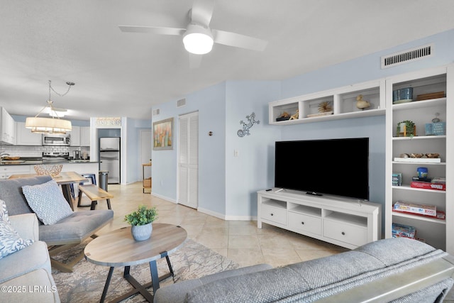 tiled living room featuring ceiling fan