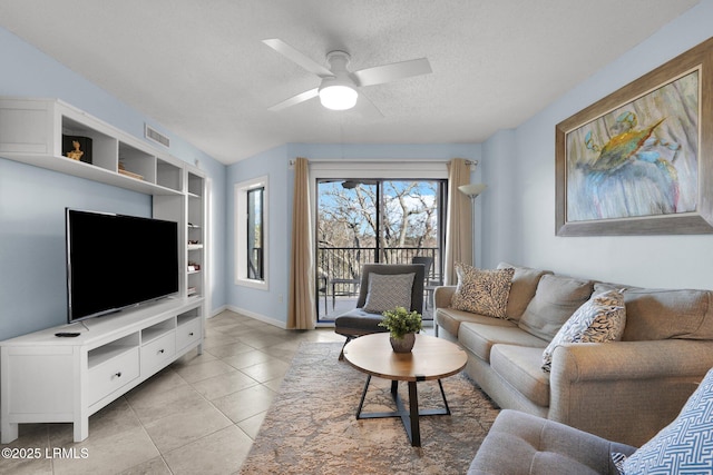 living room featuring light tile patterned floors, built in features, a textured ceiling, and ceiling fan