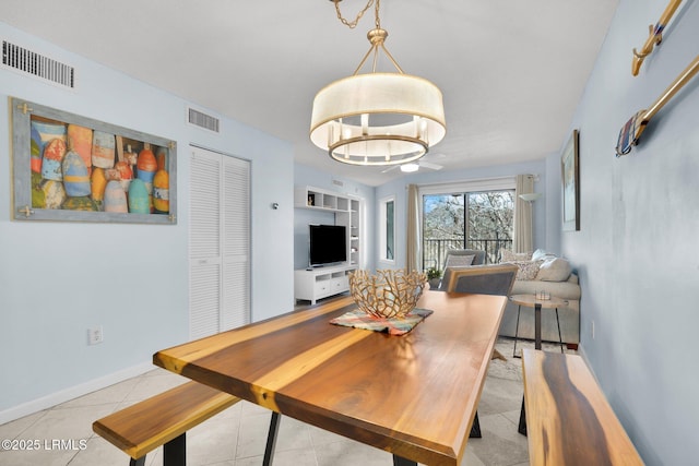 dining area with an inviting chandelier, built in features, and light tile patterned floors