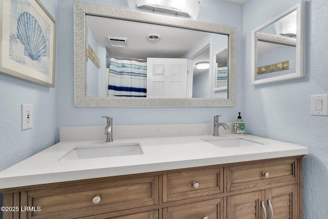 bathroom featuring vanity and curtained shower