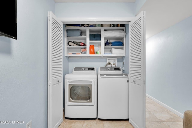 laundry area featuring separate washer and dryer and light tile patterned floors