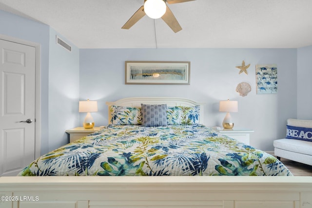 bedroom with a textured ceiling and ceiling fan