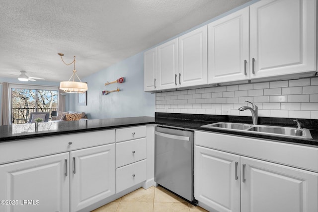 kitchen featuring tasteful backsplash, white cabinetry, dishwasher, sink, and light tile patterned floors