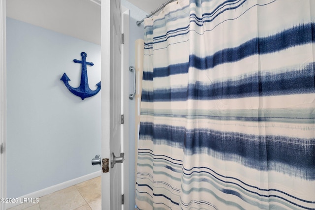 bathroom with walk in shower and tile patterned floors