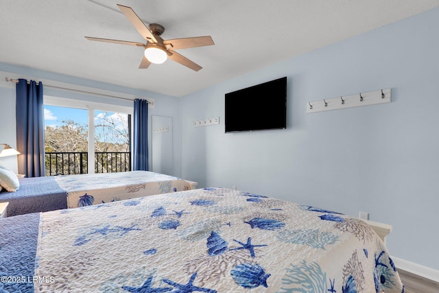 bedroom with hardwood / wood-style floors, access to outside, and ceiling fan