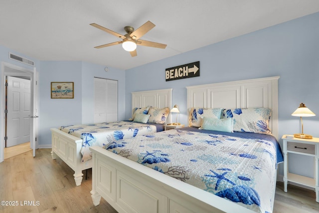 bedroom featuring ceiling fan, light wood-type flooring, and a closet