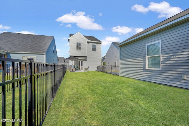 view of yard with a fenced backyard and a residential view