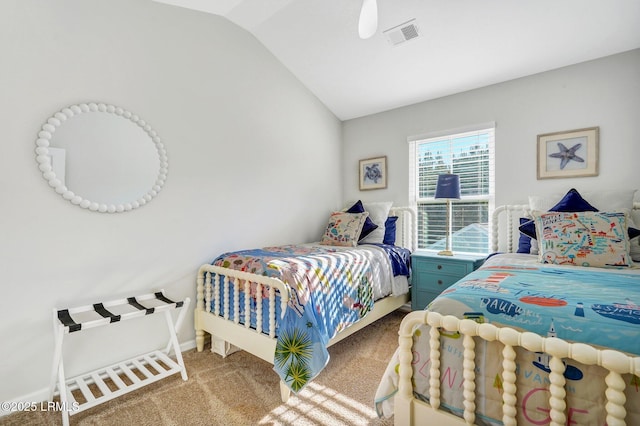 carpeted bedroom with visible vents and vaulted ceiling