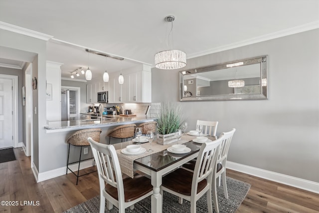21 S Forest Beach Dr Unit 210, Hilton Head Island, SC 29928 - dining space featuring crown molding, dark wood-style flooring, and a chandelier