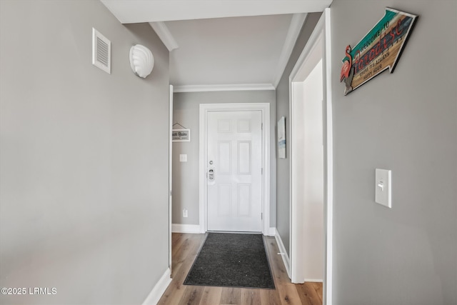 21 S Forest Beach Dr Unit 210, Hilton Head Island, SC 29928 - doorway to outside featuring crown molding and wood finished floors