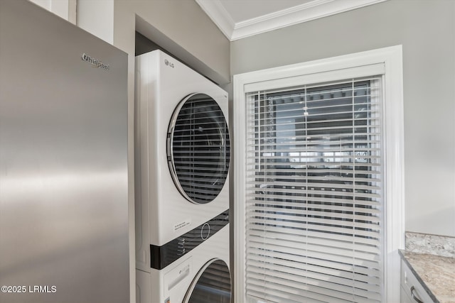21 S Forest Beach Dr Unit 210, Hilton Head Island, SC 29928 - laundry room with stacked washer / dryer and crown molding