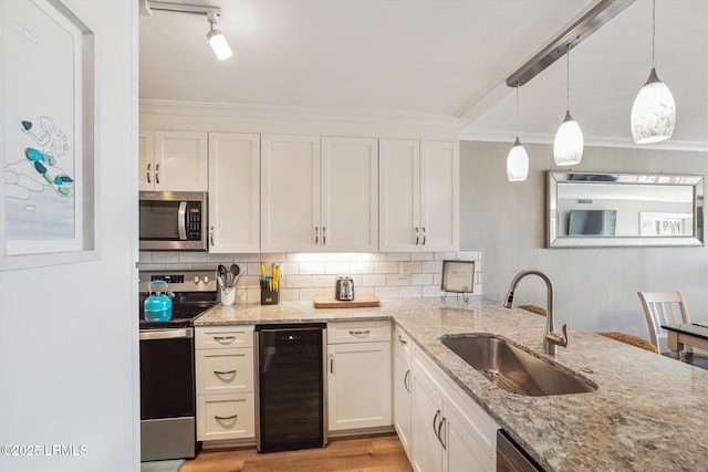 21 S Forest Beach Dr Unit 210, Hilton Head Island, SC 29928 - kitchen with appliances with stainless steel finishes, beverage cooler, crown molding, and white cabinetry