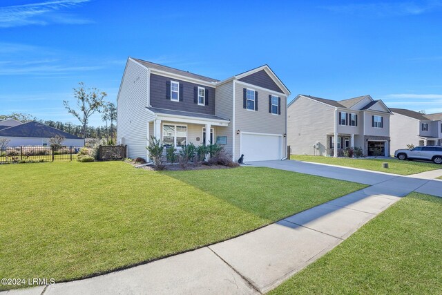 view of front of property with a garage and a front lawn