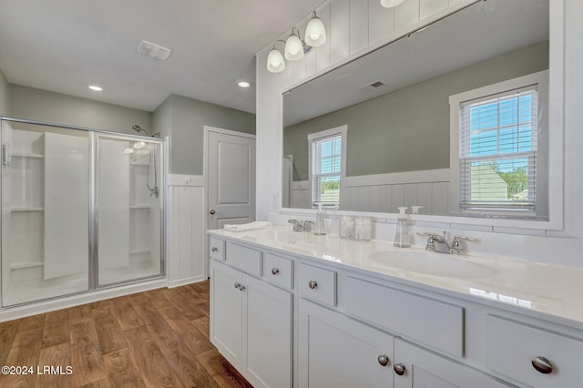 bathroom featuring vanity, a shower with shower door, and hardwood / wood-style floors