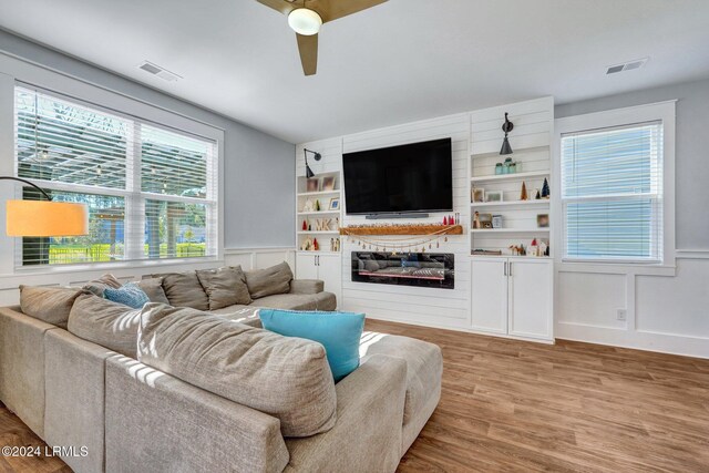 living room with hardwood / wood-style flooring and ceiling fan