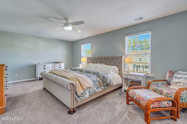 bedroom with light carpet and ceiling fan