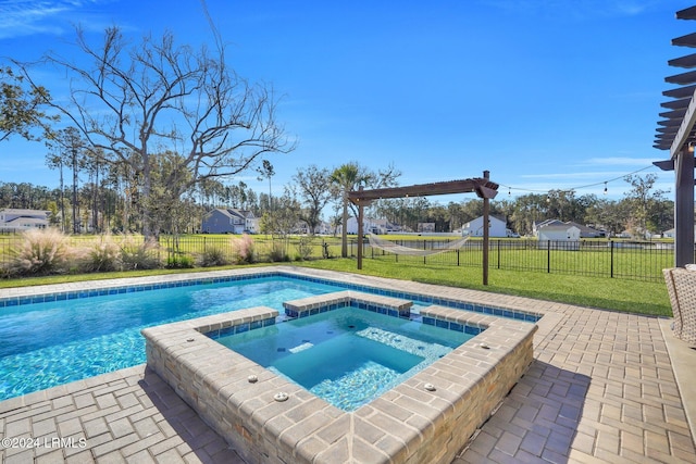 view of pool featuring a patio area, a lawn, and an in ground hot tub