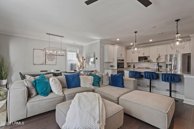 living room with dark wood finished floors, recessed lighting, ornamental molding, visible vents, and a ceiling fan